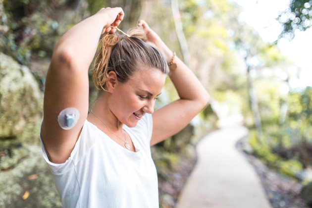 Woman with diabetes tech visible in upper arm smiles Woman-with-diabetes-tech-in-arm-630x420