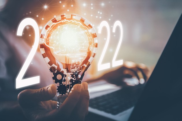 2022 date in bright lights alongside someone working at a laptop