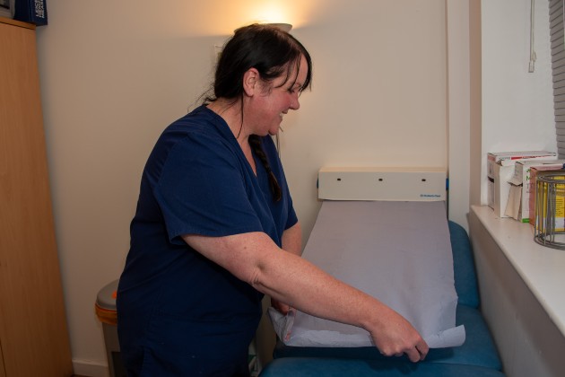 School nurse Sarah preparing examination bed