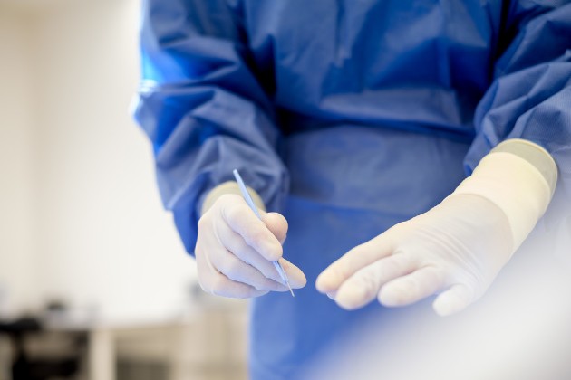 Close up on hands of surgical nurse Sara Dalby holding a scalpel