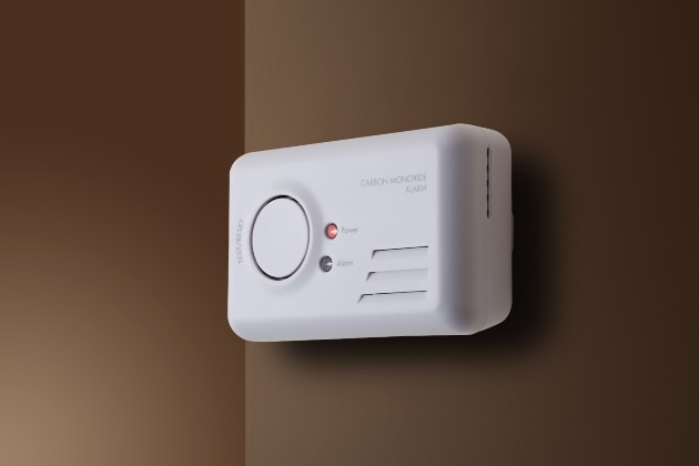 Stock image of carbon monoxide alarm show attached to a wall
