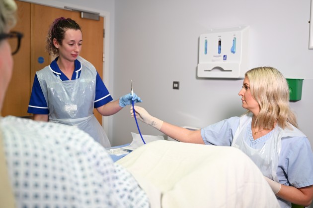 Nurse hysteroscopist Vicky Burns in Causeway Hospital Northern Ireland works with colleague to carry out a hysteroscopy