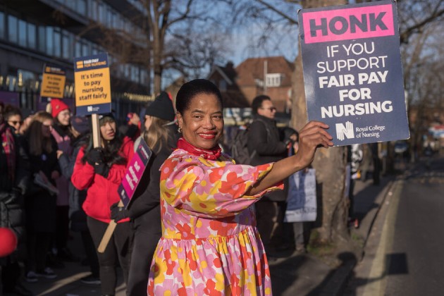 An RCN member holds a Fair Pay For Nursing placard in front of the picket line at Kings Hospital London on 19 January 2023