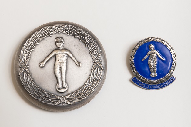 two silver belt buckles with engraved child