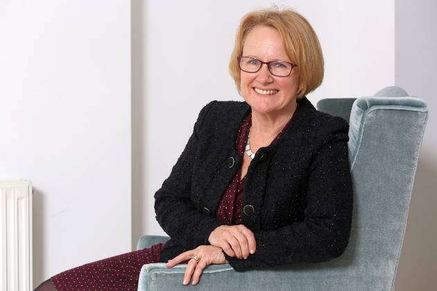 Baroness Mary Watkins sitting on chair