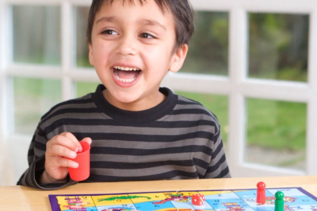 Child playing snakes and ladders_stock image