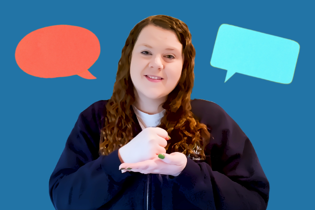 A woman faces the camera, making the Makaton sign for "help", with her right hand closed into a fist on top of the open palm of her left hand. She has long, dark red hair and is smiling. Her image is cut out and appears on a dark blue background with 2 speech bubbles either side of her, one red and one light blue.
