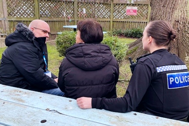 Ian Fairburn with colleagues having conversation on a bench