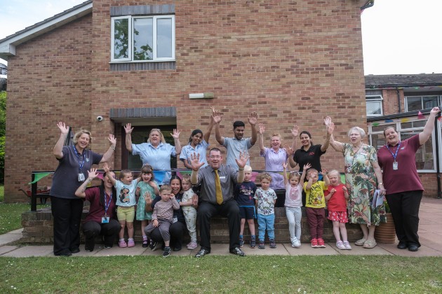 Staff and children waving outside Bryn Marl Nursing Home
