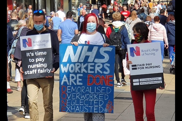 Mel Kerr with NHS pay placard sign