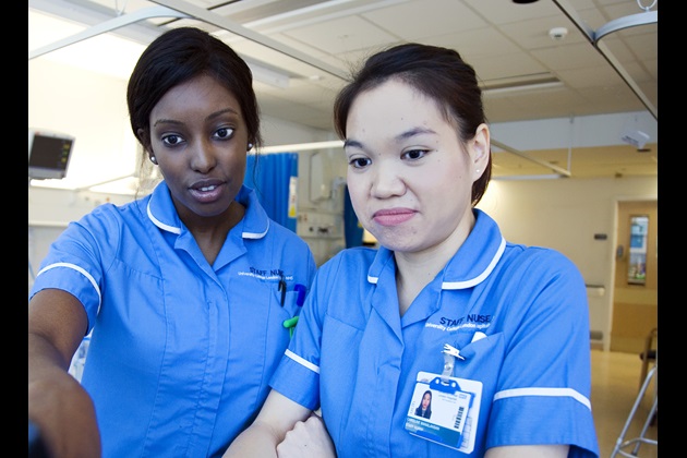 Two nurses review patient notes