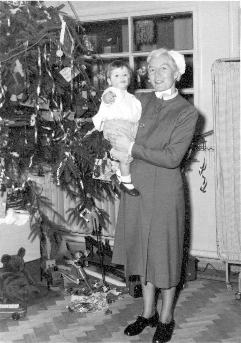 A nurse poses with a baby