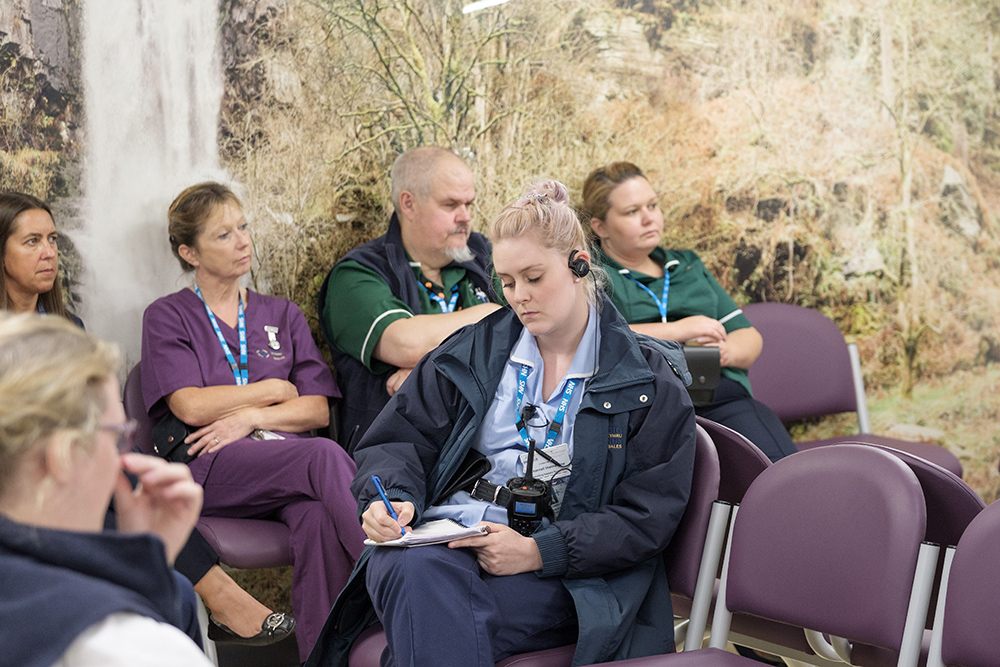 Health care staff gather for a meeting at HMP Berwyn