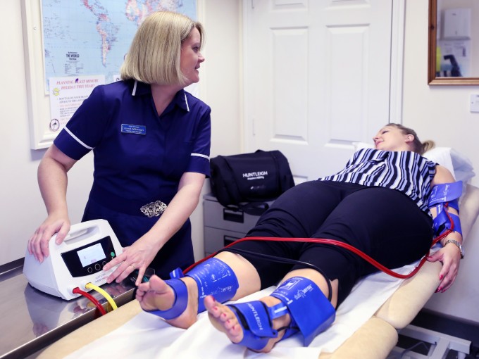 Nurse Emma Williamson performs a Doppler test on a patient during a wound care clinic