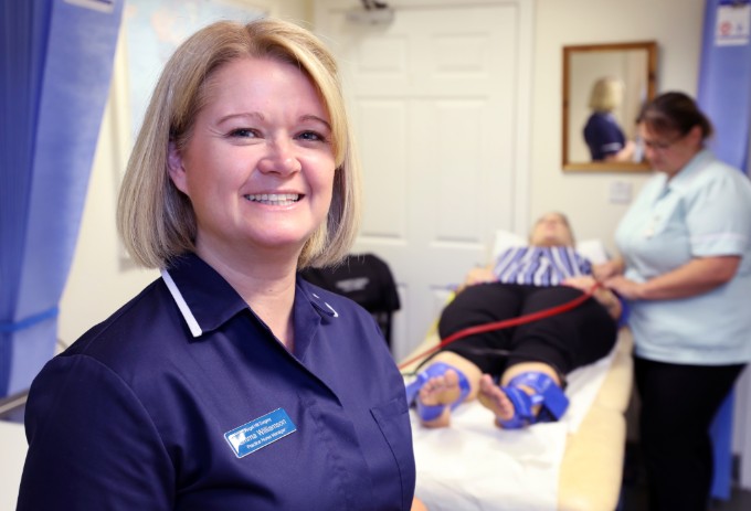 Nurse Emma Williamson pictured next to a healthcare support worker performing a Doppler test