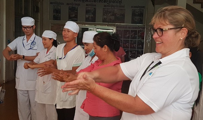 Nursing volunteer Sally does a hand-washing demo with staff in a Cambodian hospital