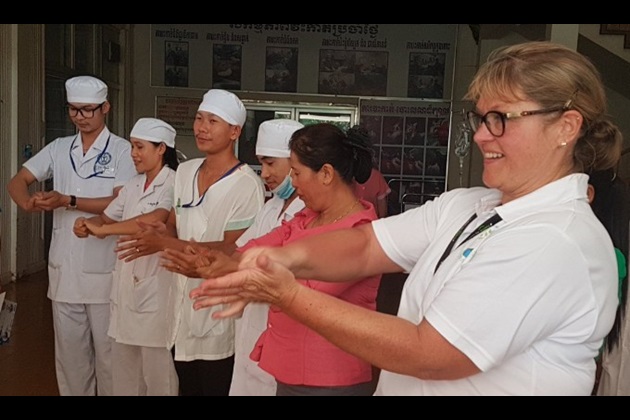 Nursing volunteer Sally does a hand-washing demo with staff in a Cambodian hospital