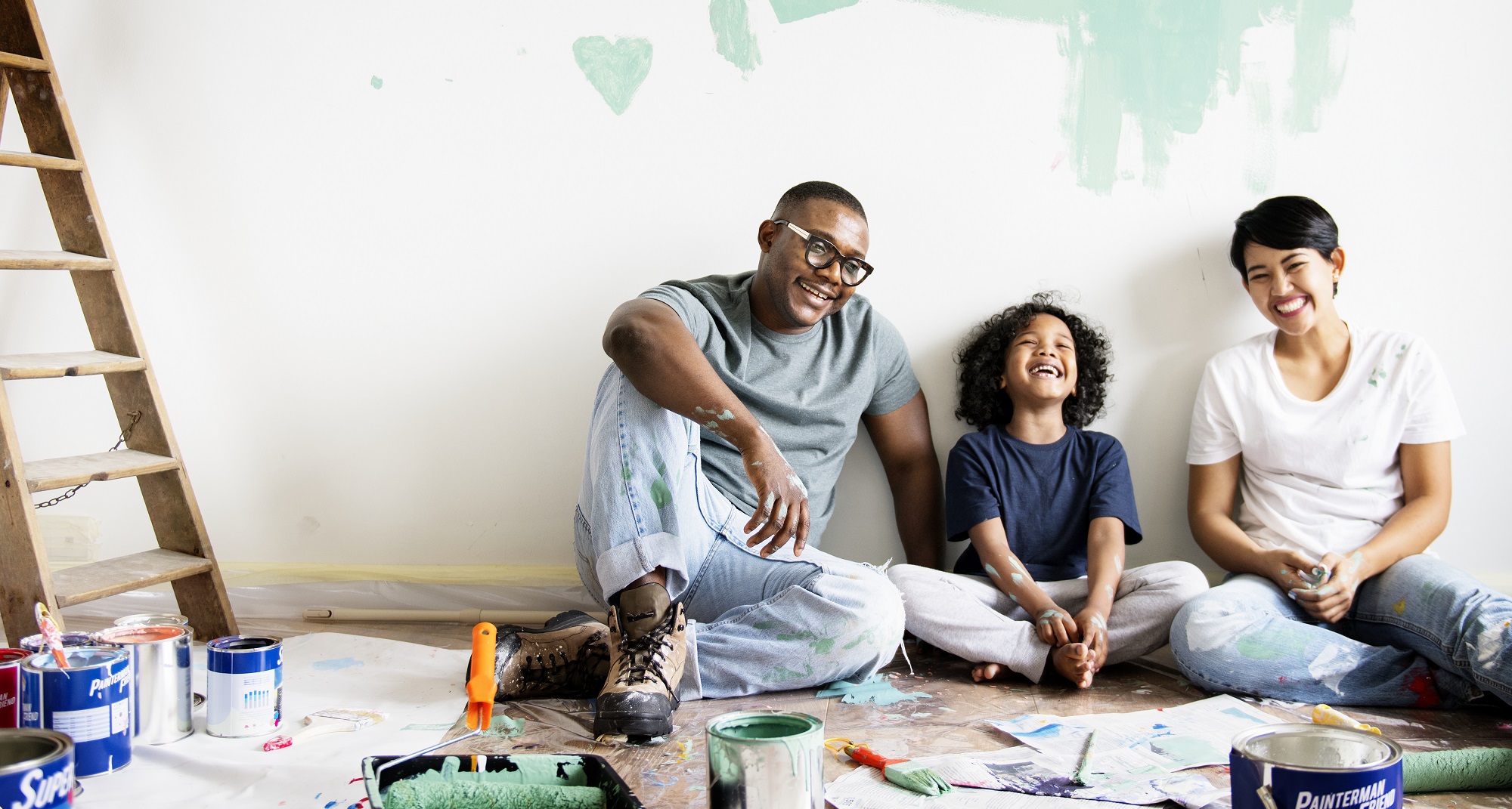 Parents and a child decorating and smiling