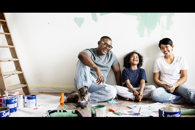 Parents and a child decorating and smiling
