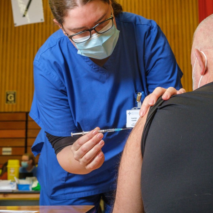 Nurse Louise Cahill administers a COVID-19 vaccine at the mass vaccination centre where she works as clinical coordinator, in Newport, Wales