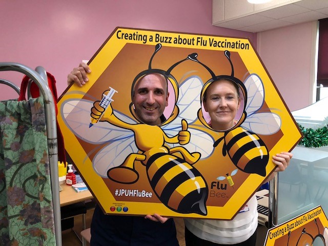 Joan Pons Laplana and colleague with flu bee advertising