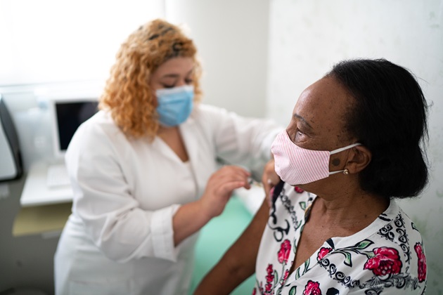 Nurse vaccinating someone else with masks on