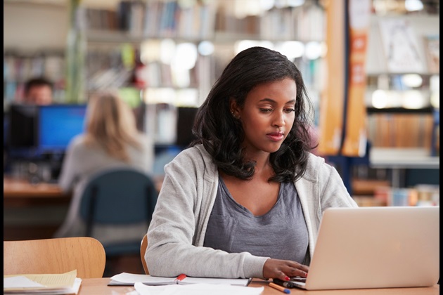 Mature student working in library