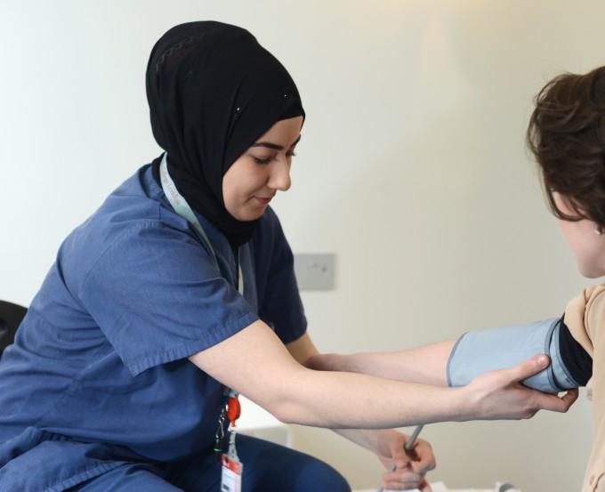 Nursing student Ozlem Top takes blood pressure at Marie Stopes clinic