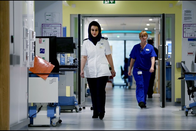Nursing student in hospital corridor with headscarf