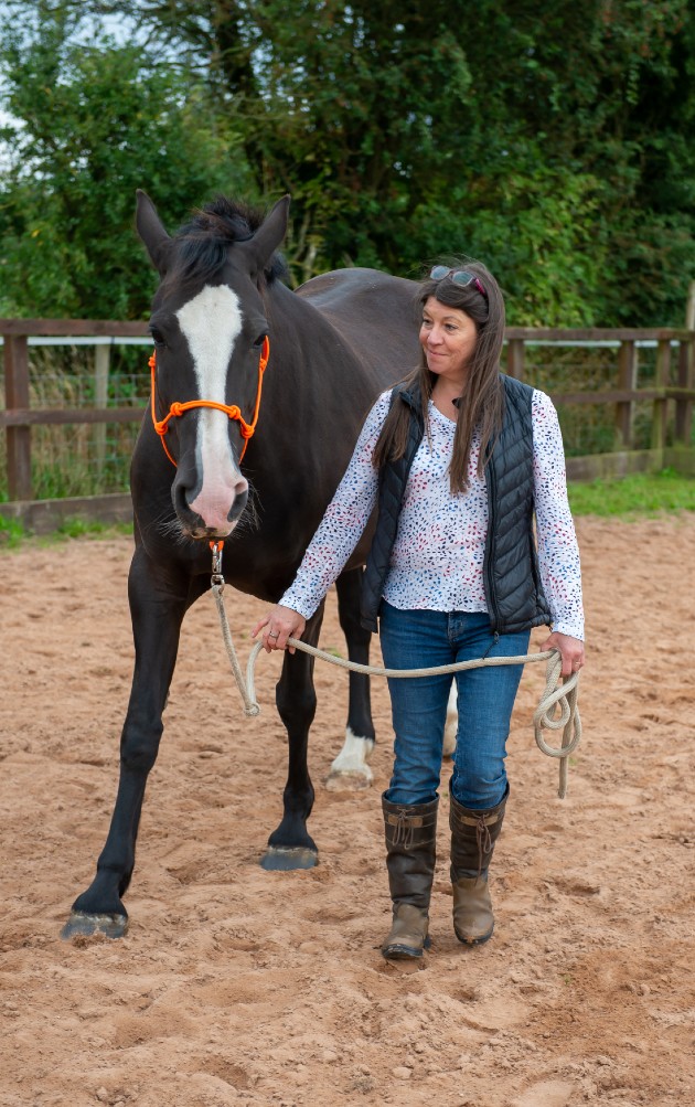 Amanda in riding school with one of the therapy horses