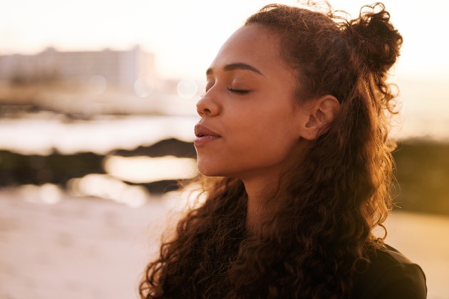 Woman outside taking a deep breath