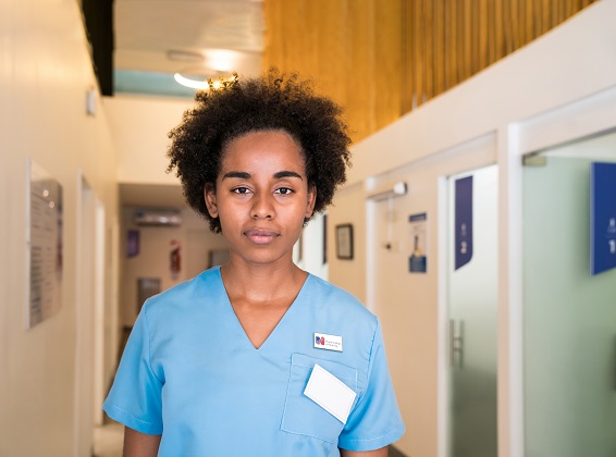 A mixed race nurse staring at the camera