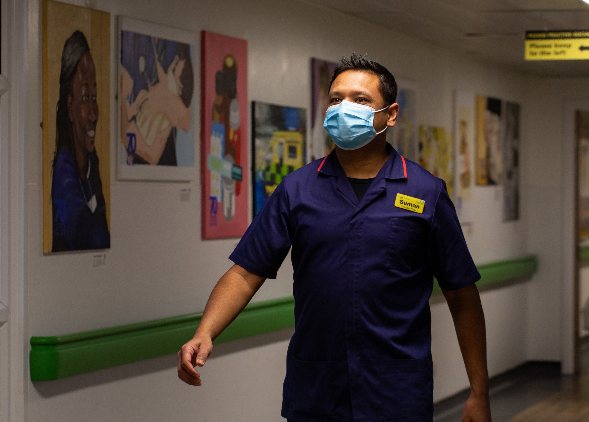 RCN Professional Lead for Critical Care Suman Shrestha strides down a corridor inside Frimley Hospital 