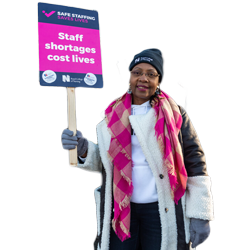 A nurse holding a sign that says "staff shortages cost lives"