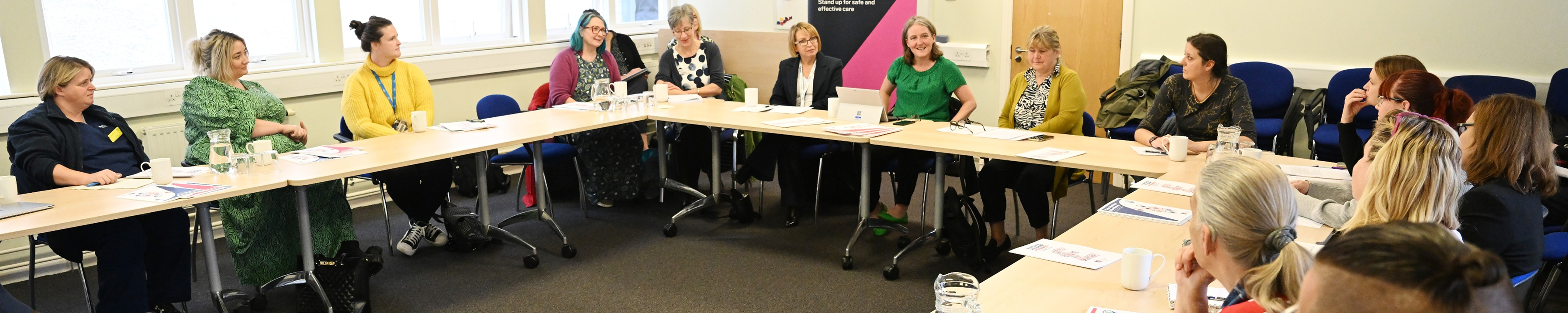 People holding a meeting around a large table