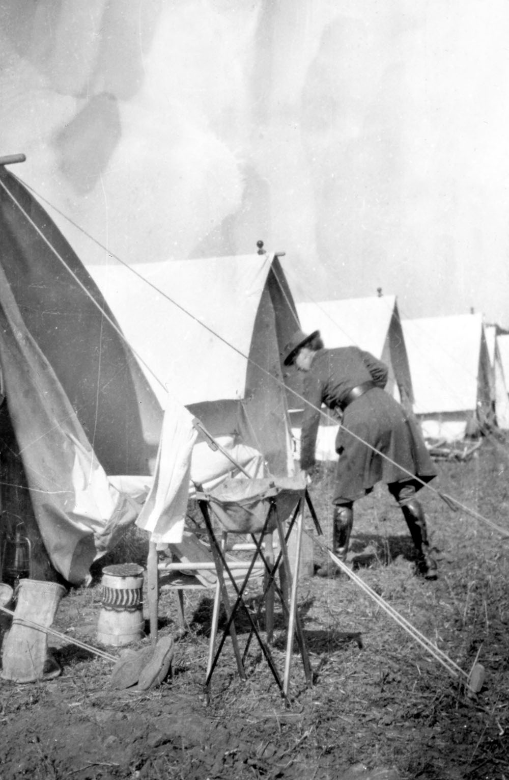 A field of tents with an orderly and washstand in the foreground, possibly in Medjidia the Russian HQ of the Scottish Women’s Hospitals in the Dobrudja district of Romania.