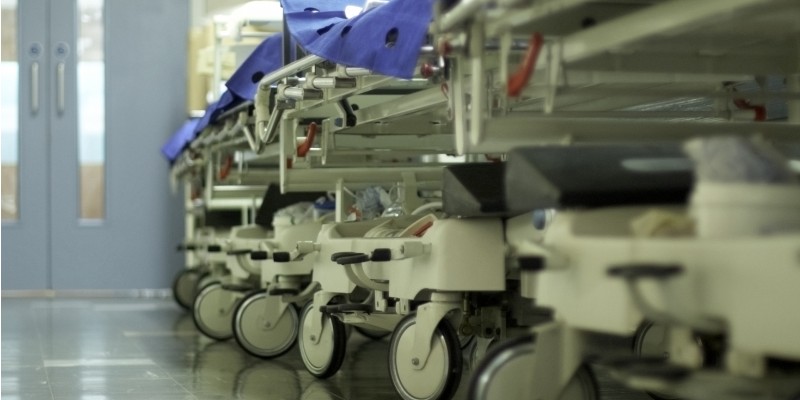 A row of hospital beds in a corridor